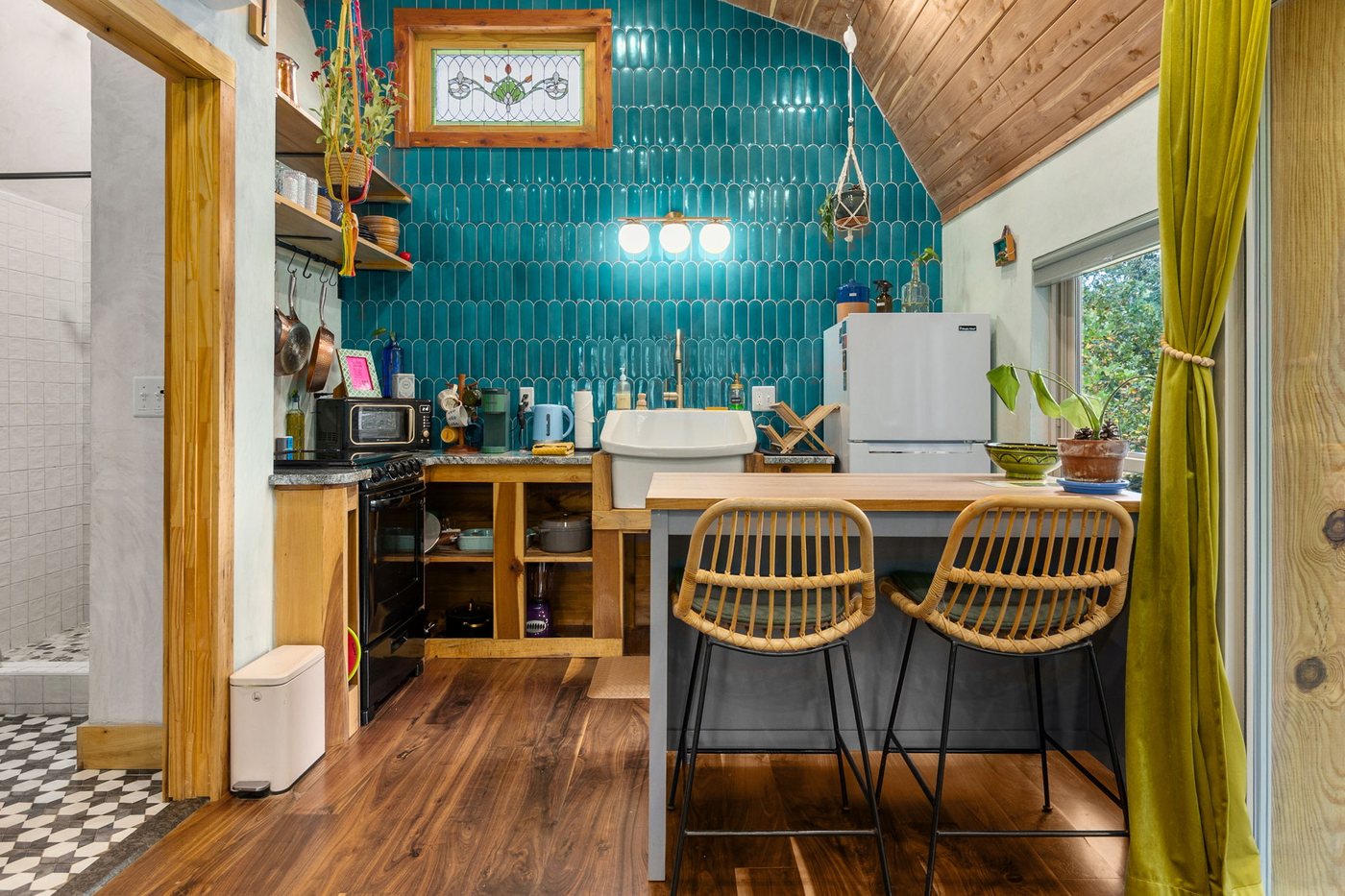 Blackbird kitchen with teal tile, farmhouse sink and bar stools