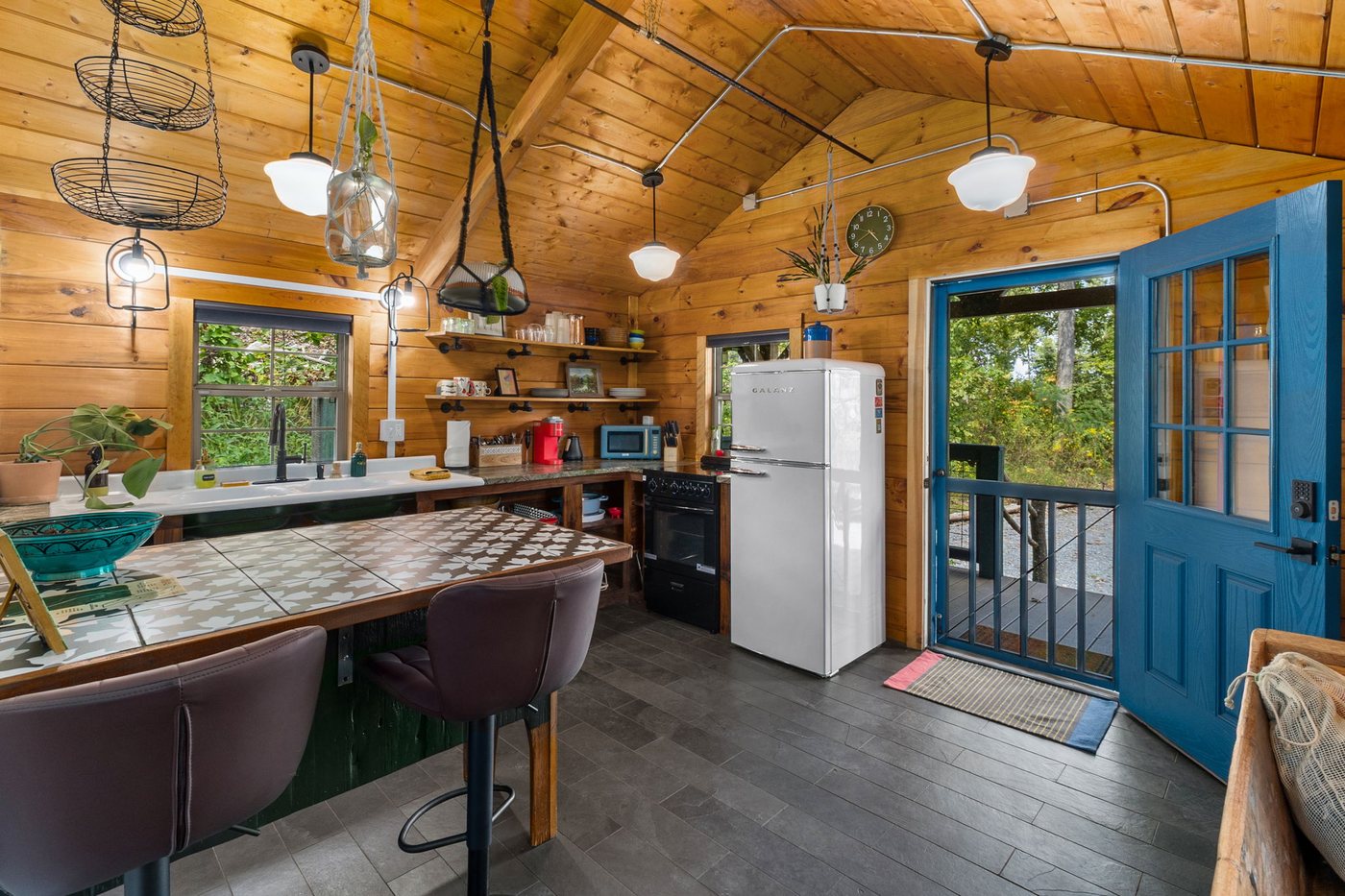 Chickadee kitchen with open shelving and tile counter