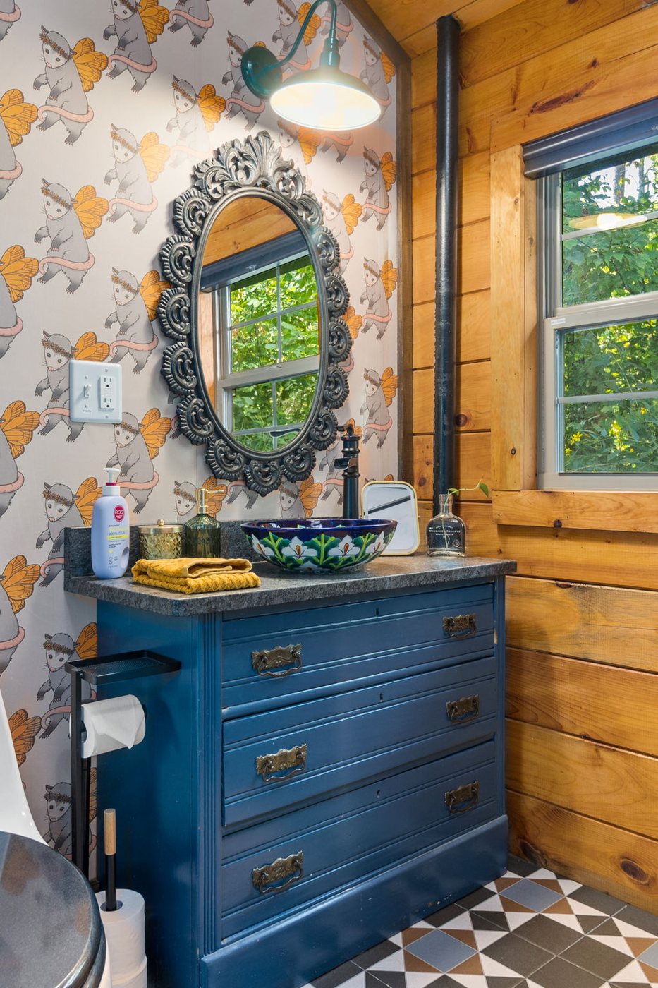 Chickadee bathroom with ornate mirror and painted vessel sink