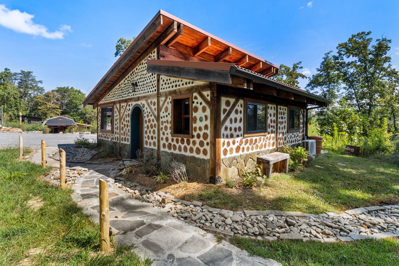 Goldfinch cordwood cabin exterior at Talking Water