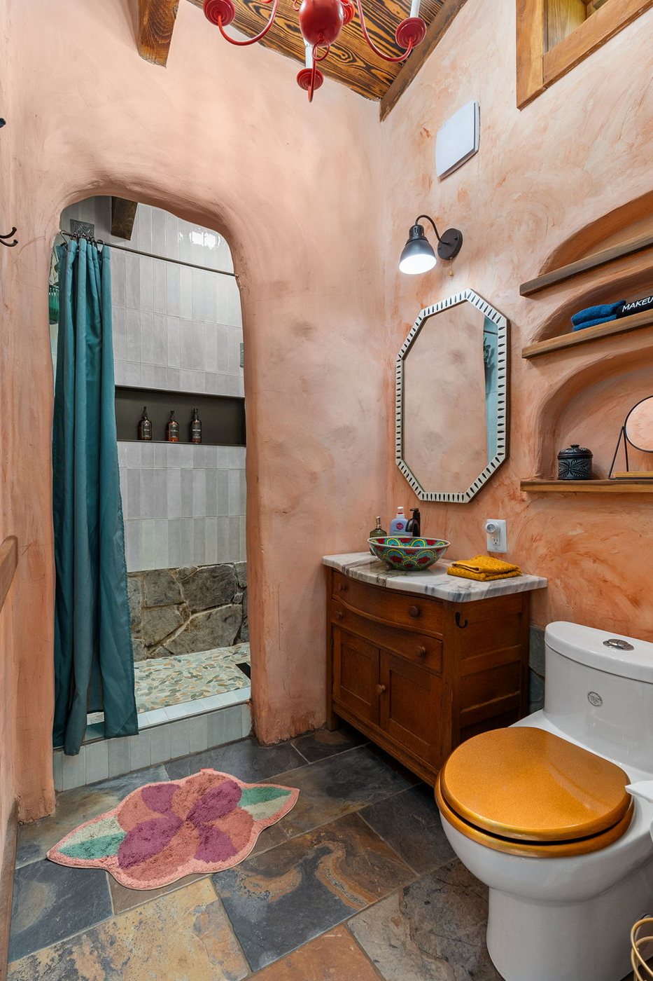 Goldfinch whimsical earthen bathroom with an arched mirror