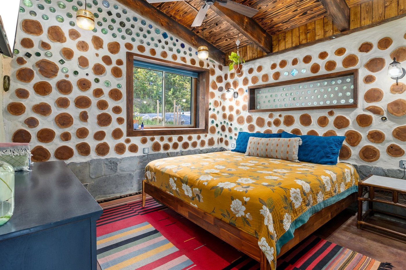 Goldfinch king bed in the semi-private bedroom with cordwood walls