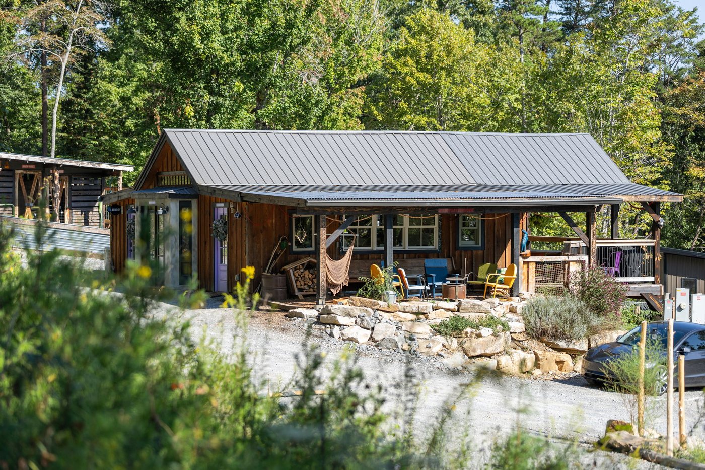 Meadowlark Bunkhouse cedar exterior with covered porch at Talking Water