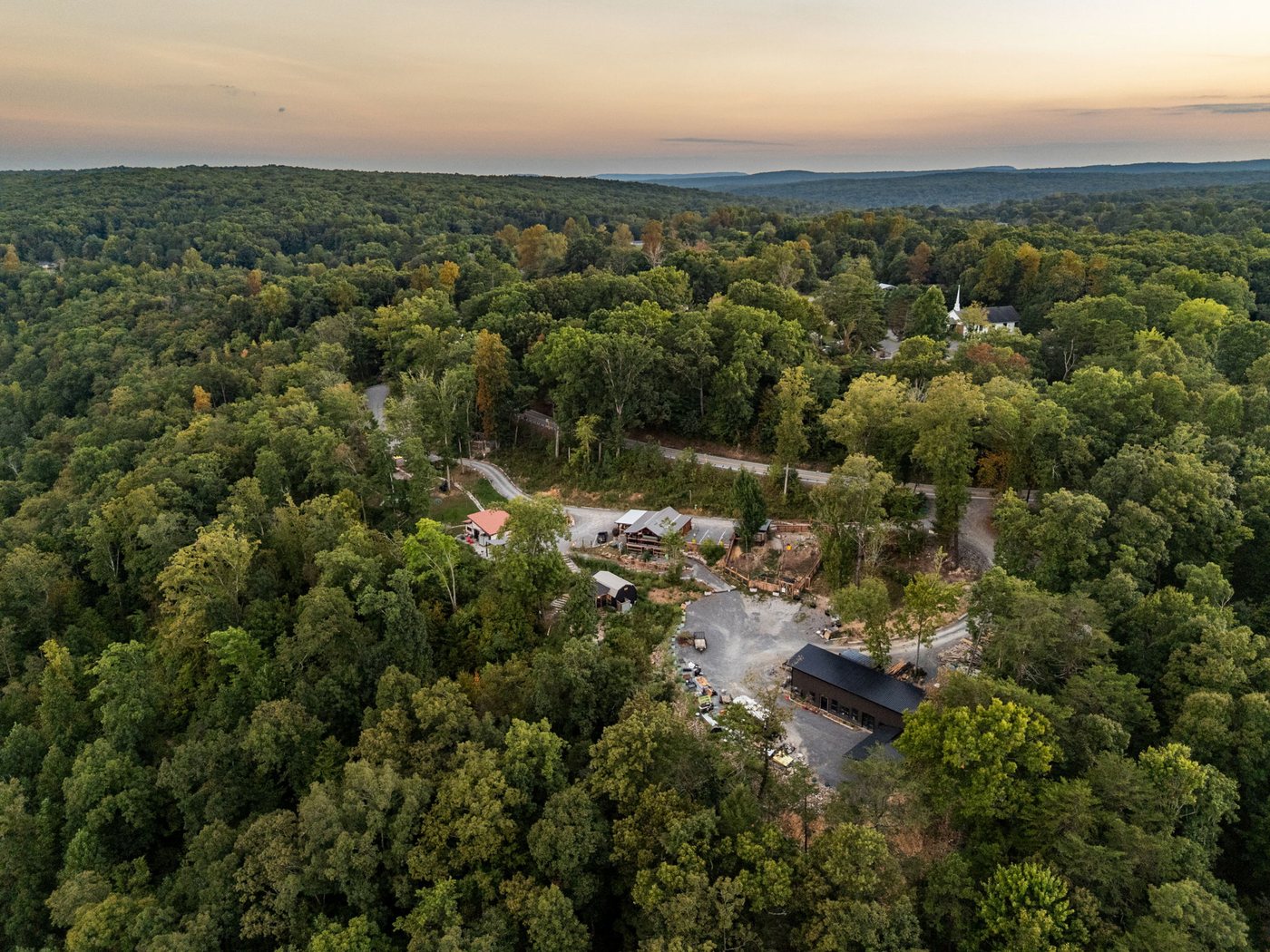 The property seen from above, framed by forest