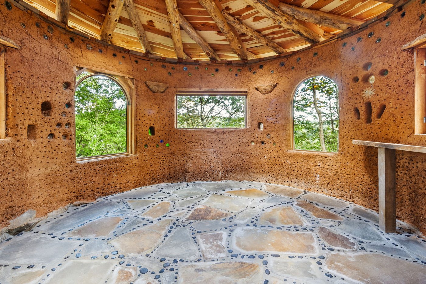 Inside the ceremony hut, arched windows and stone floor