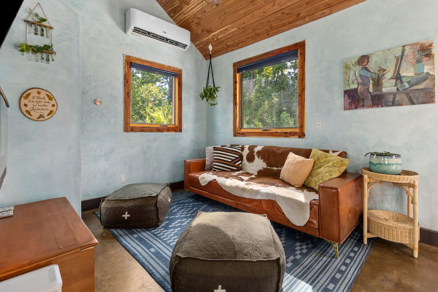 Whippoorwill living room with leather sleeper sofa and cowhide throw