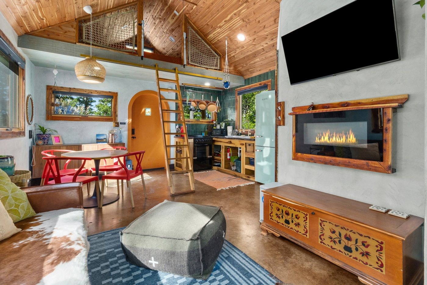 Whippoorwill open interior with loft ladder, dining nook and fireplace
