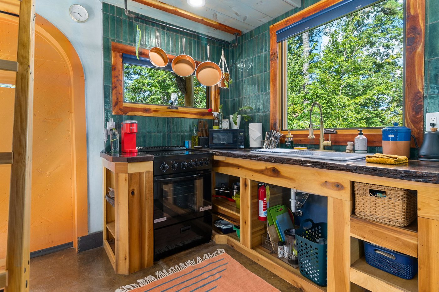Whippoorwill kitchen with teal tile and a window over the counter