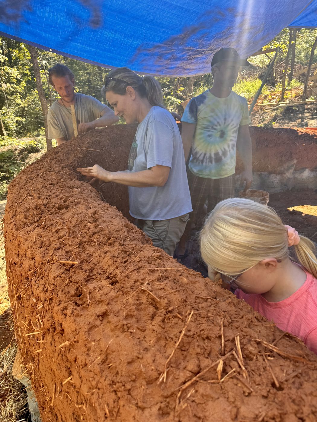 Sculpting the cob walls of the Ceremony Hut