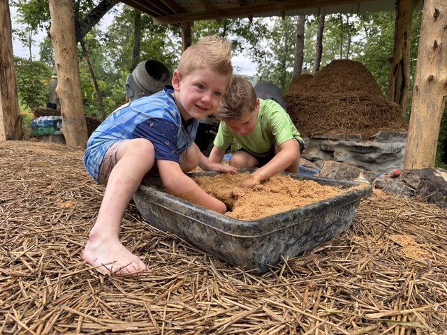 The kids mixing cob for the oven