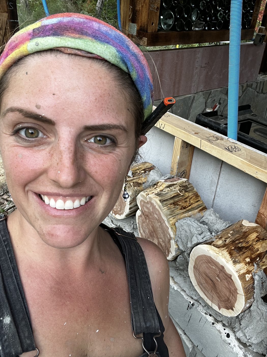 Bobbie in front of the finished cordwood wall