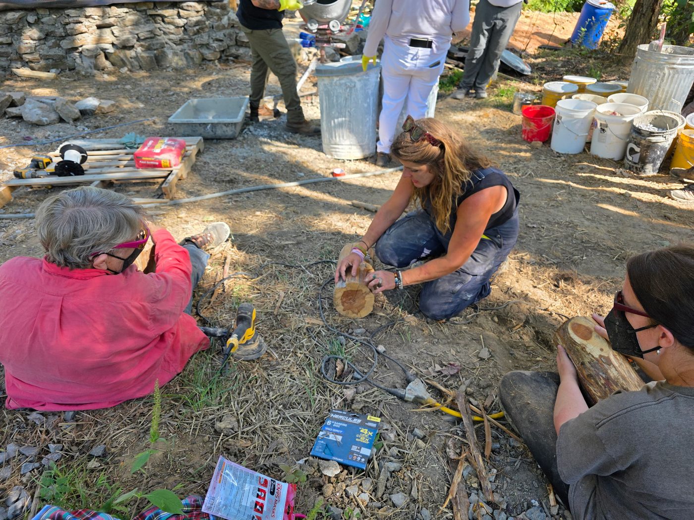 Workshop students mixing and shaping materials on site