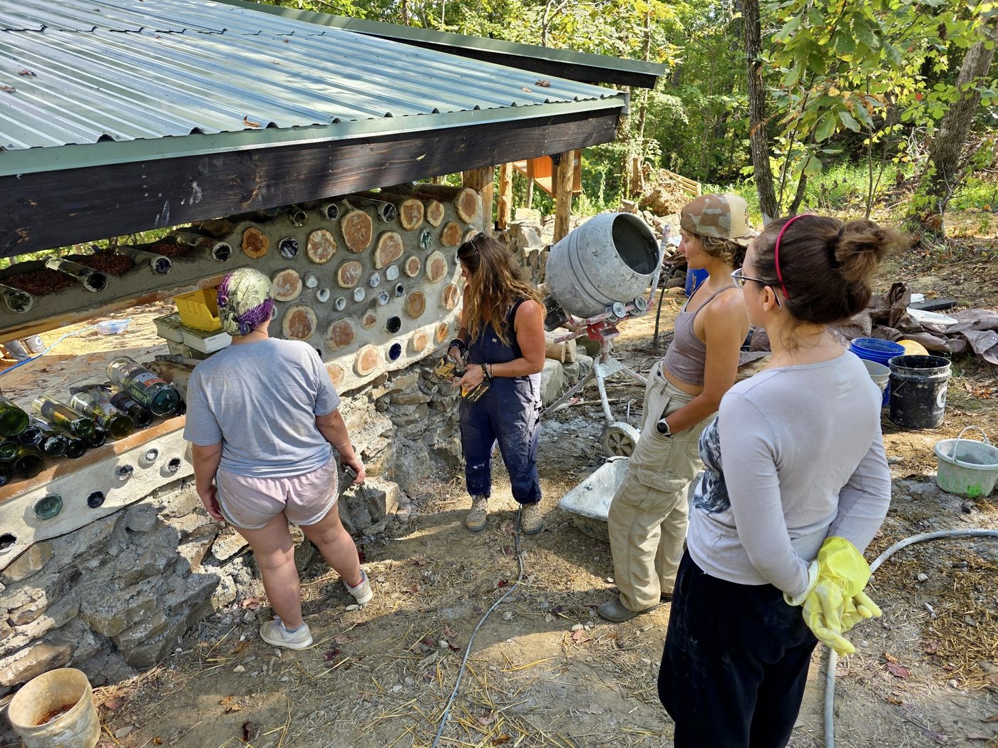 A workshop group at work on the cordwood amphitheater