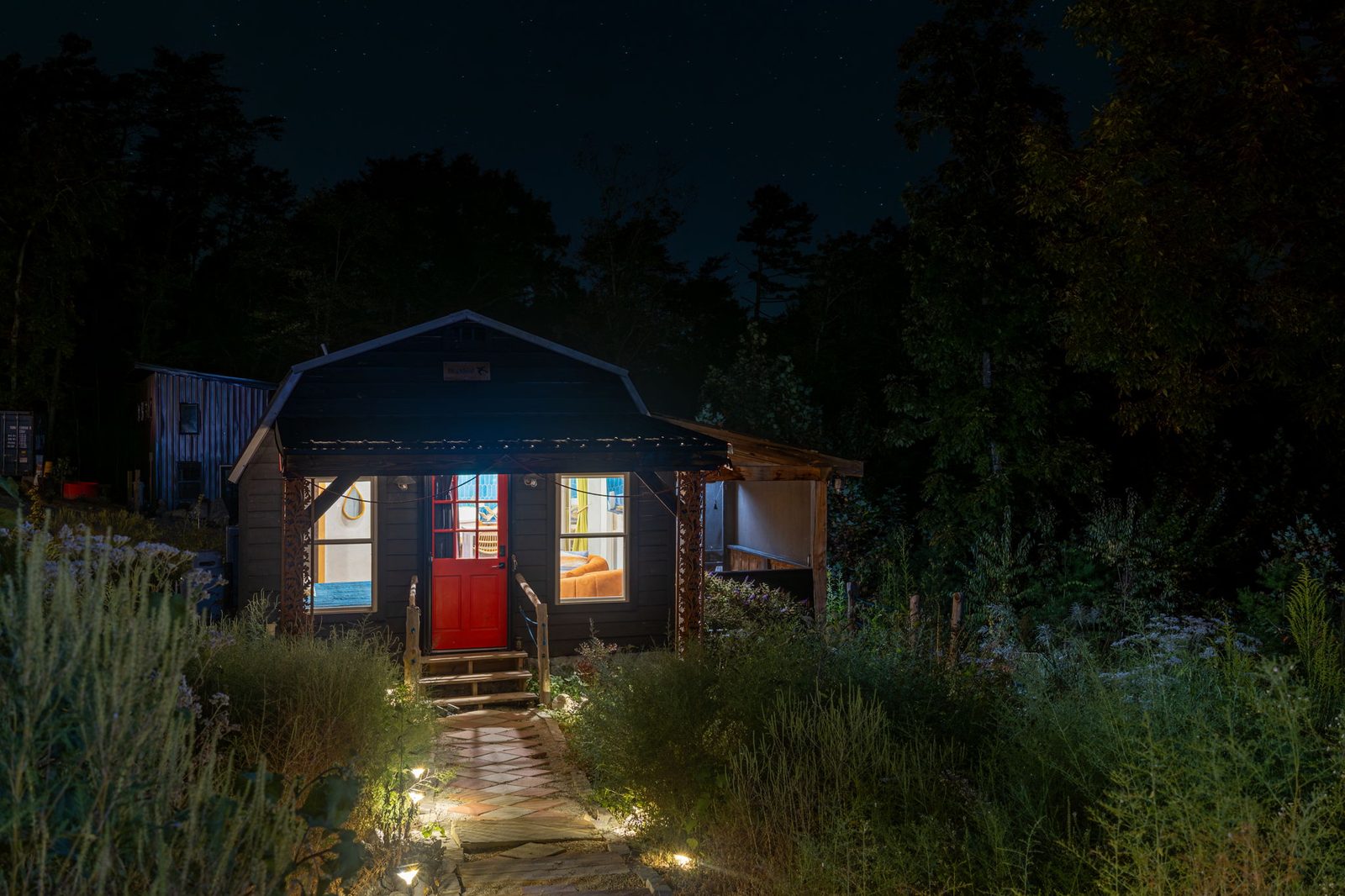 Blackbird black cabin lit up at night