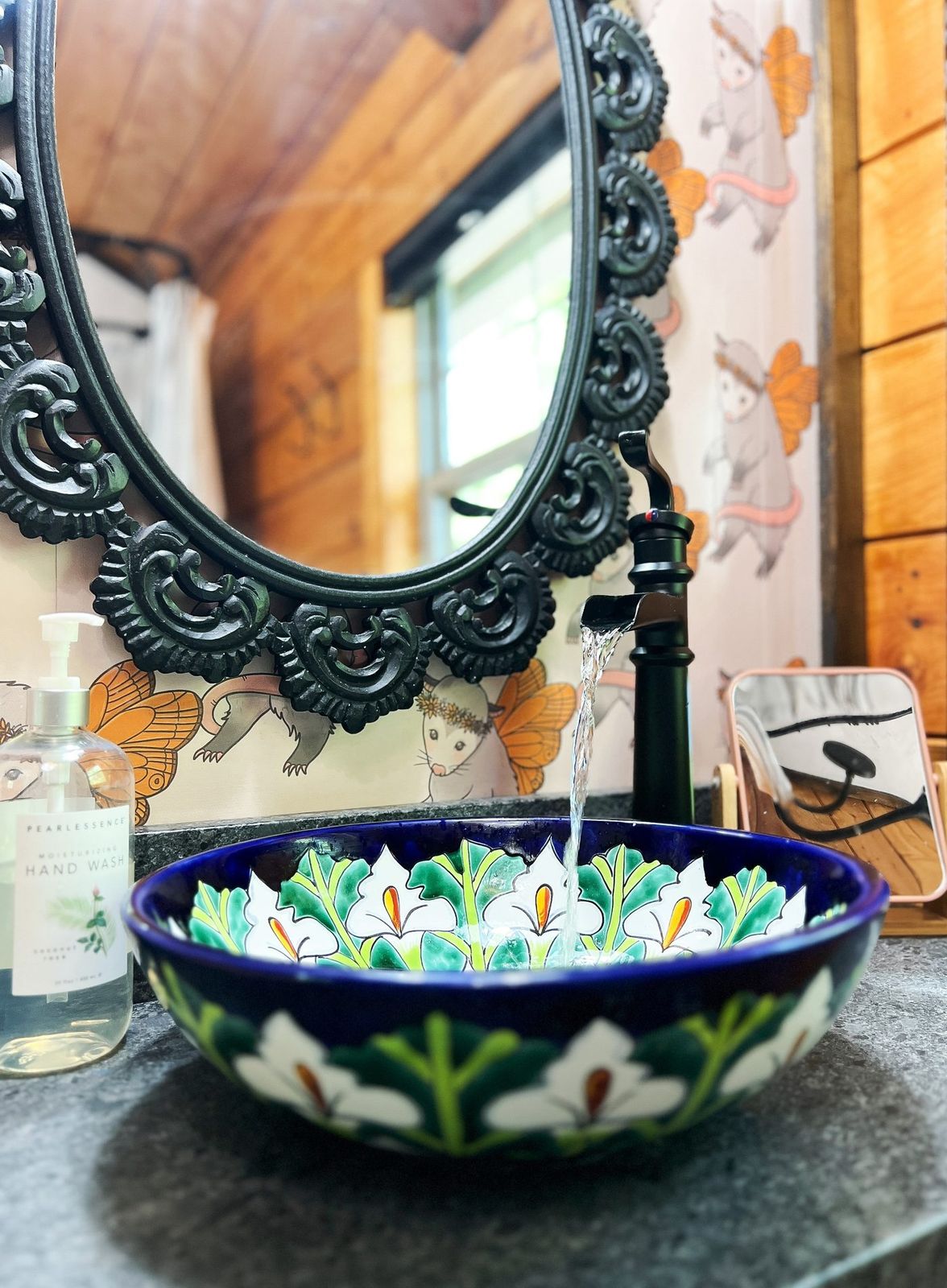 Chickadee bathroom with ornate mirror and painted vessel sink