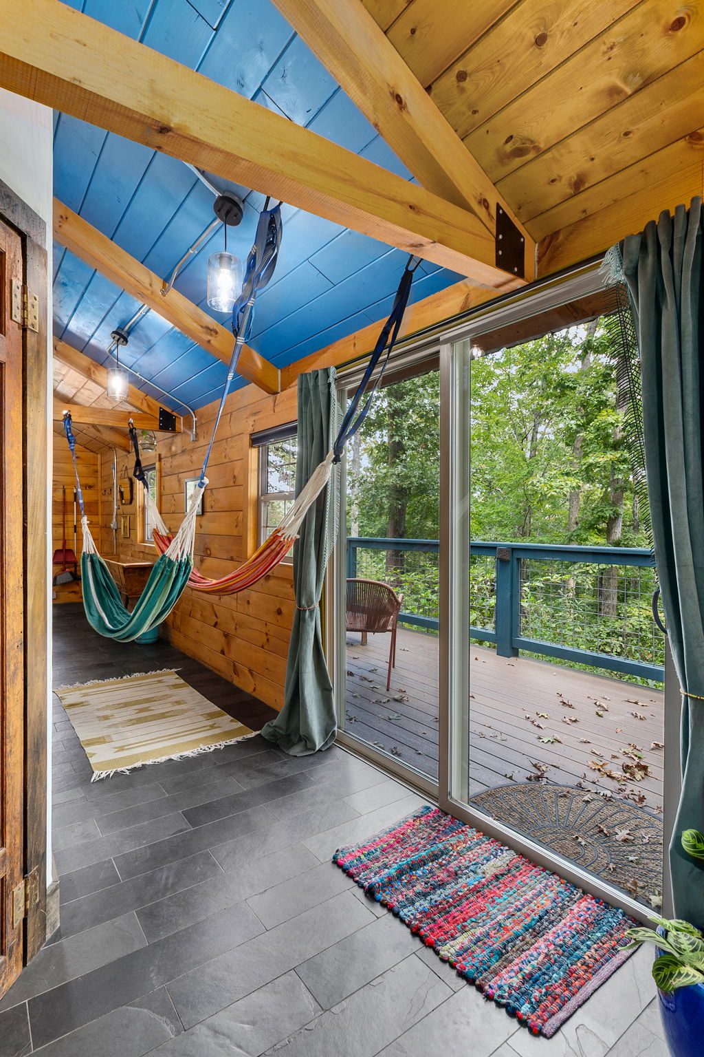 Chickadee porch hammock strung under the blue painted ceiling