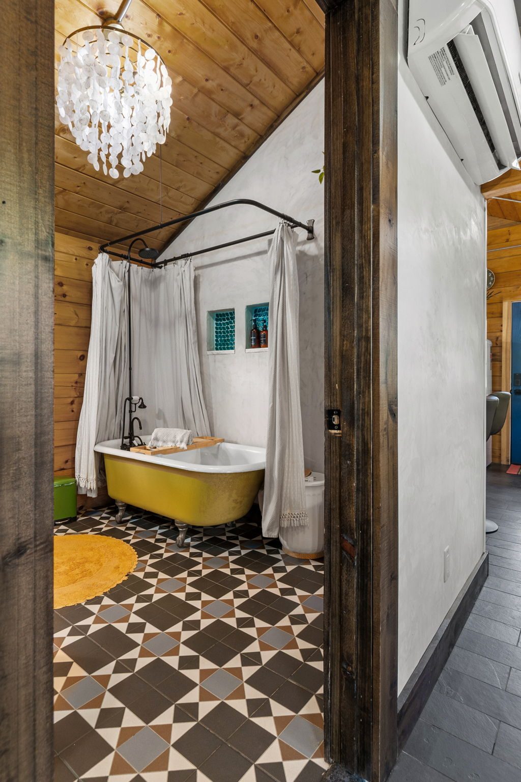Chickadee bathroom with the vintage clawfoot soaking tub and chandelier