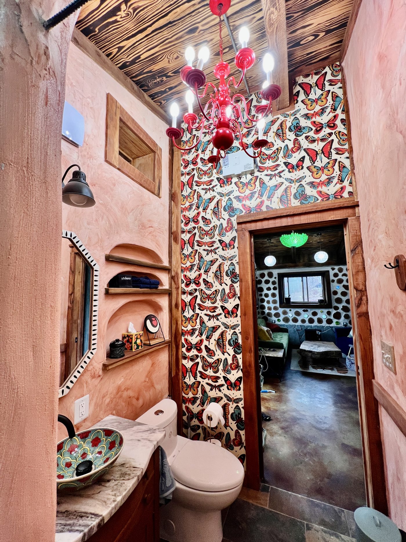 Goldfinch whimsical bathroom with bottle-glass wall