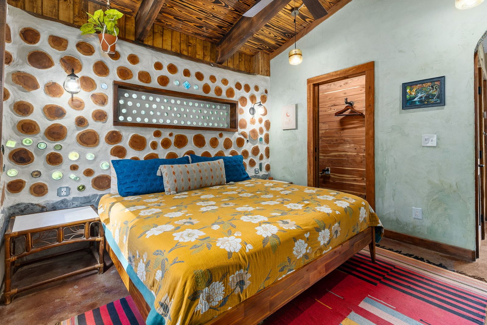 Goldfinch king bed in the semi-private bedroom with cordwood walls