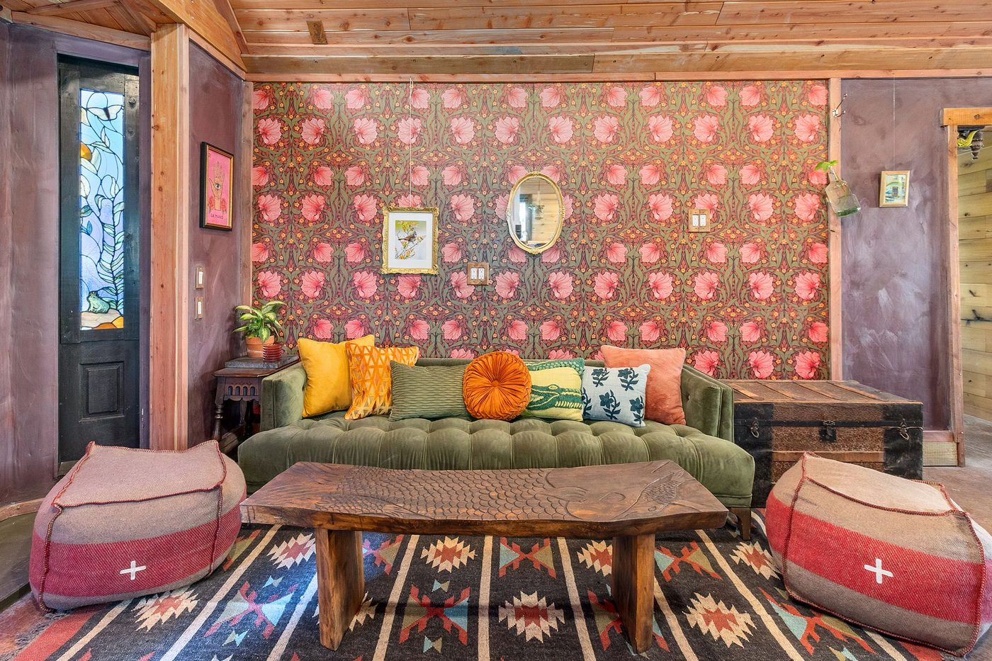 Meadowlark lounge with green sofas and patterned rug