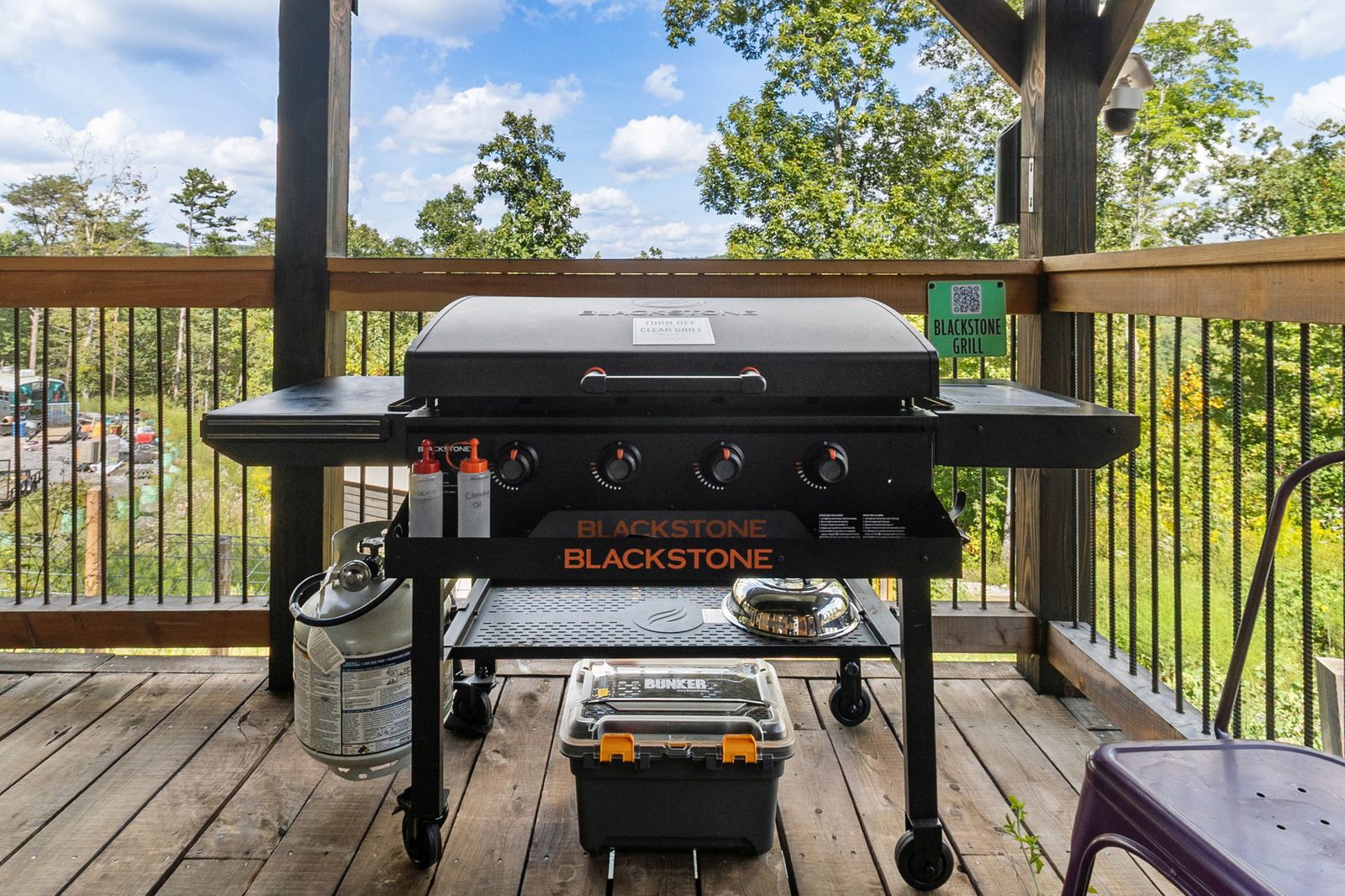 Meadowlark covered porch with the oversize dining table and 36-inch Blackstone grill