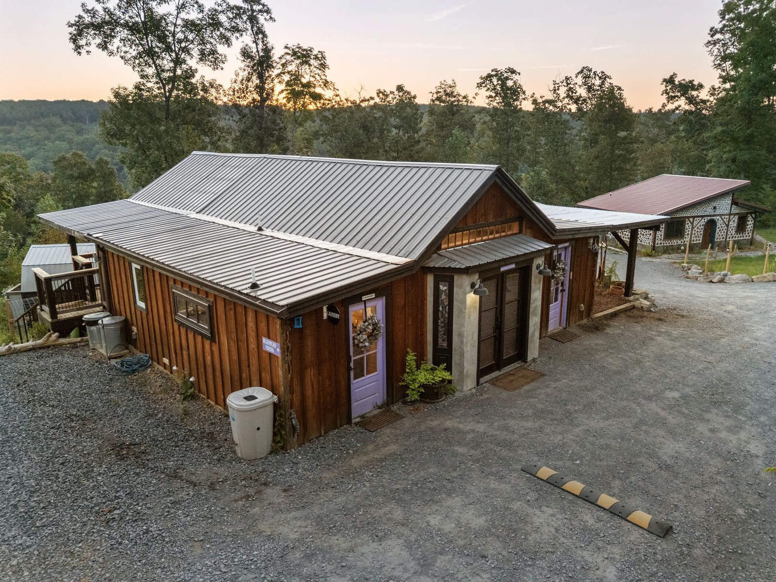 Meadowlark Bunkhouse and its lavender door at dusk