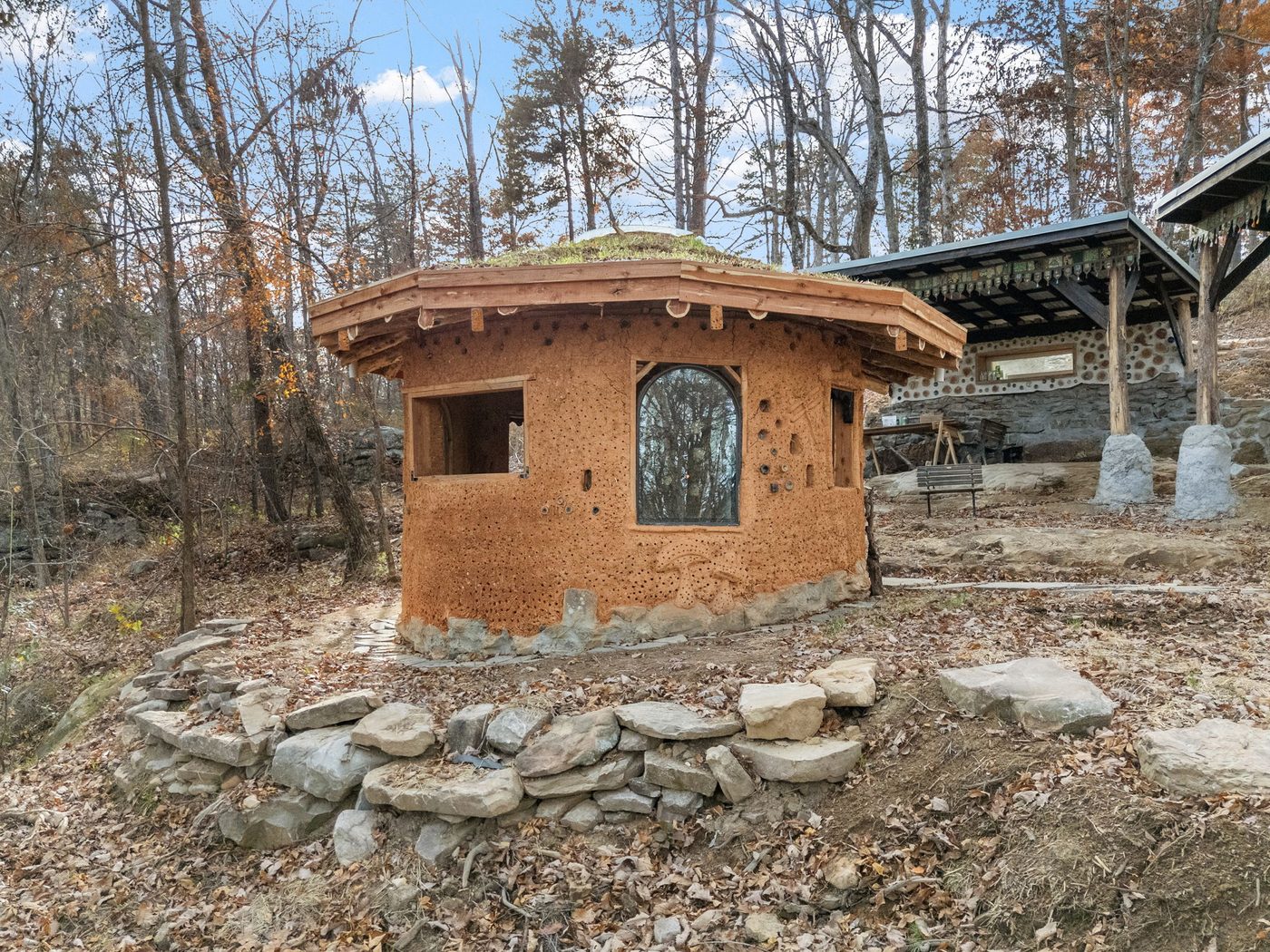 A cob building with a living green roof at Talking Water