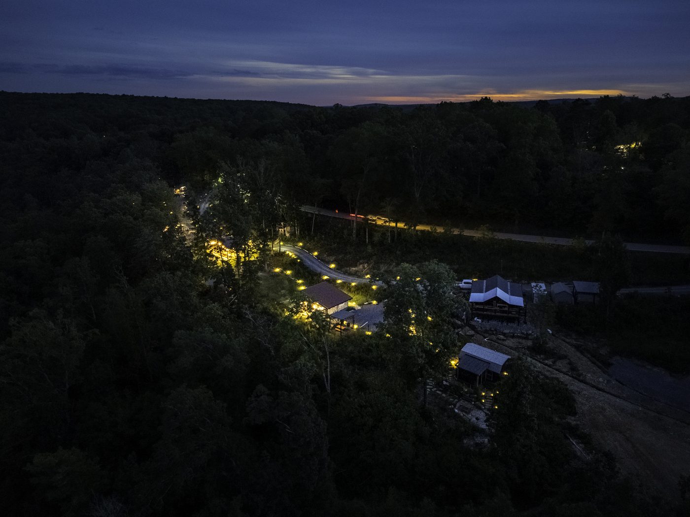 The retreat lit up at twilight, seen from above
