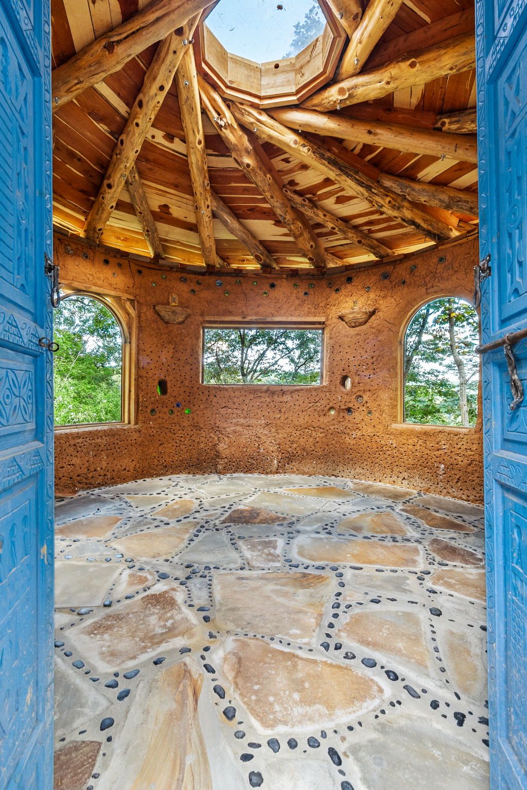 Inside the cob ceremony hut with its stone floor and arched windows
