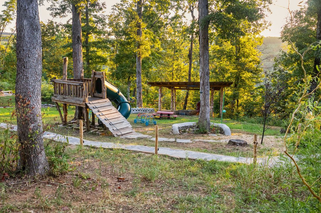 The playground and picnic area in the trees