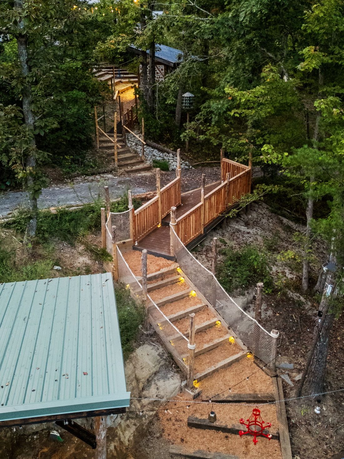 Wooden stairs winding down through the property at dusk