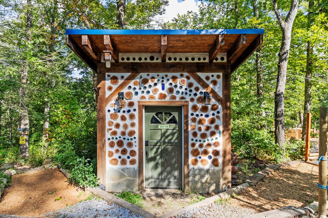 A cordwood building with bottle-glass set into the walls