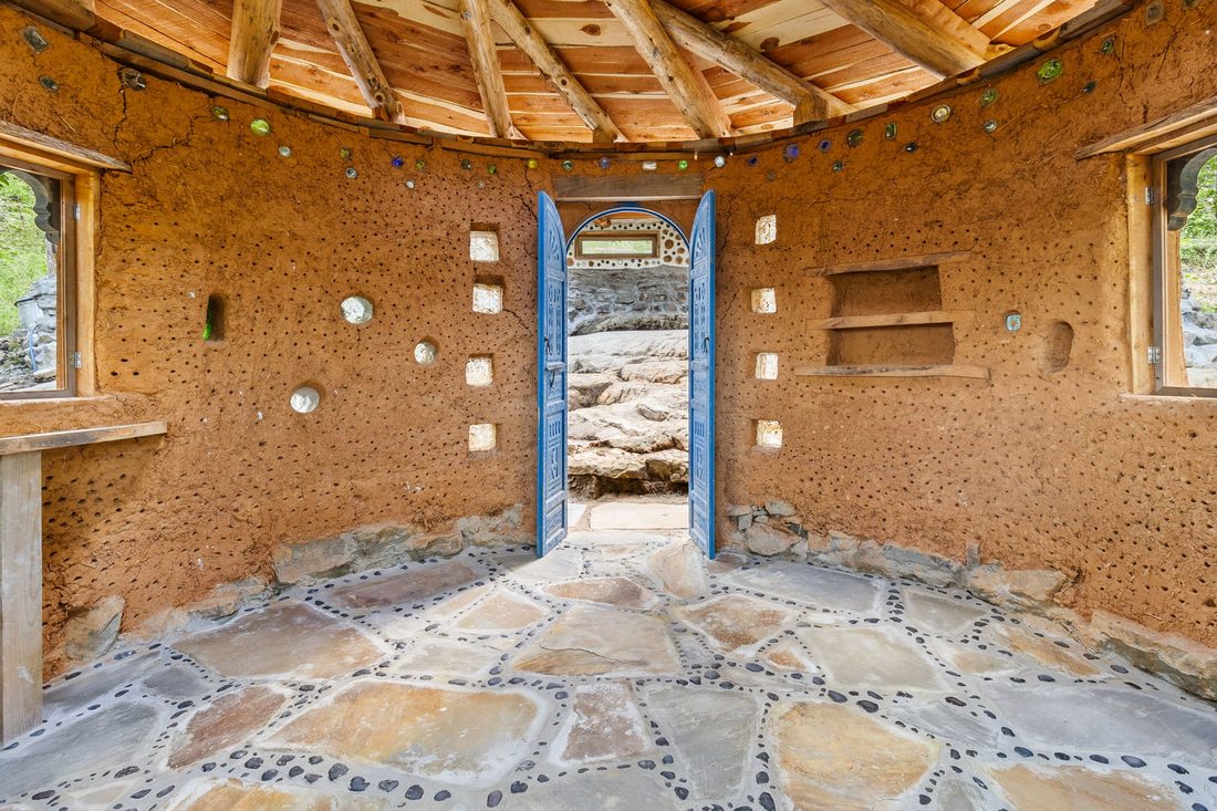 The open doorway of the cob roundhouse