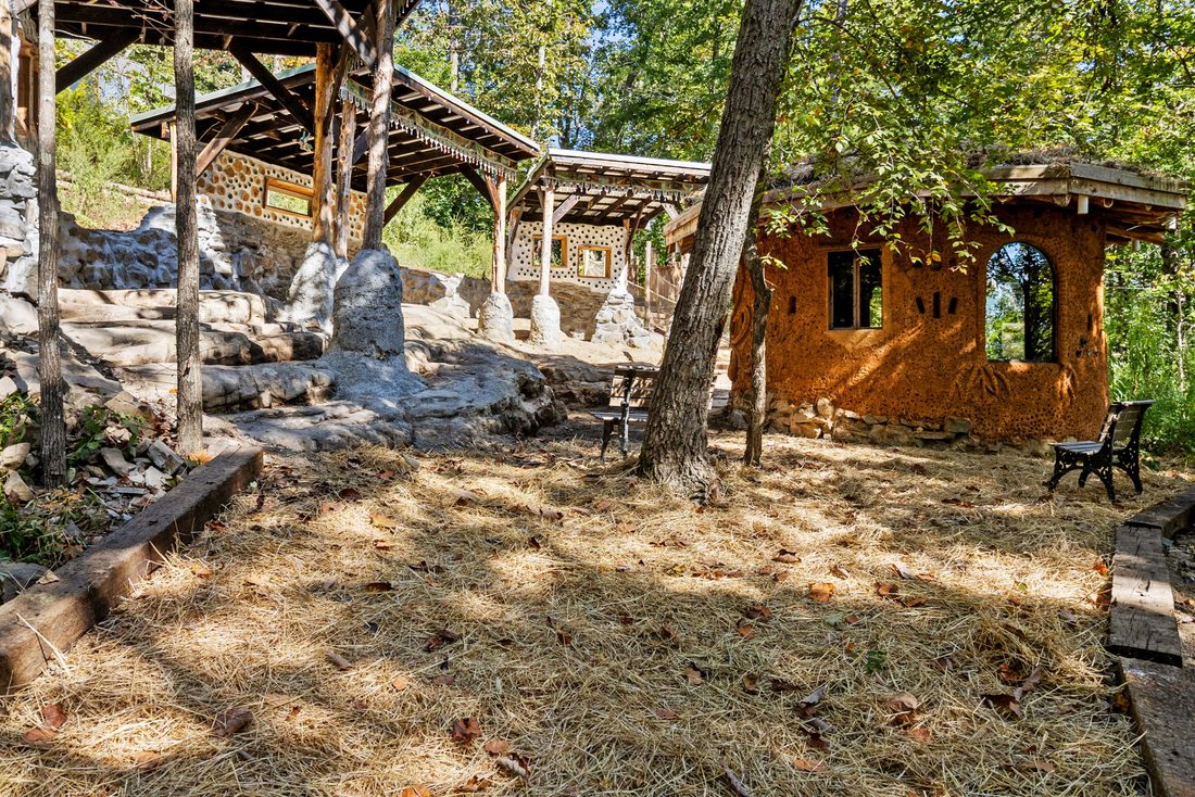 Cob buildings and timber shelters among the rocks